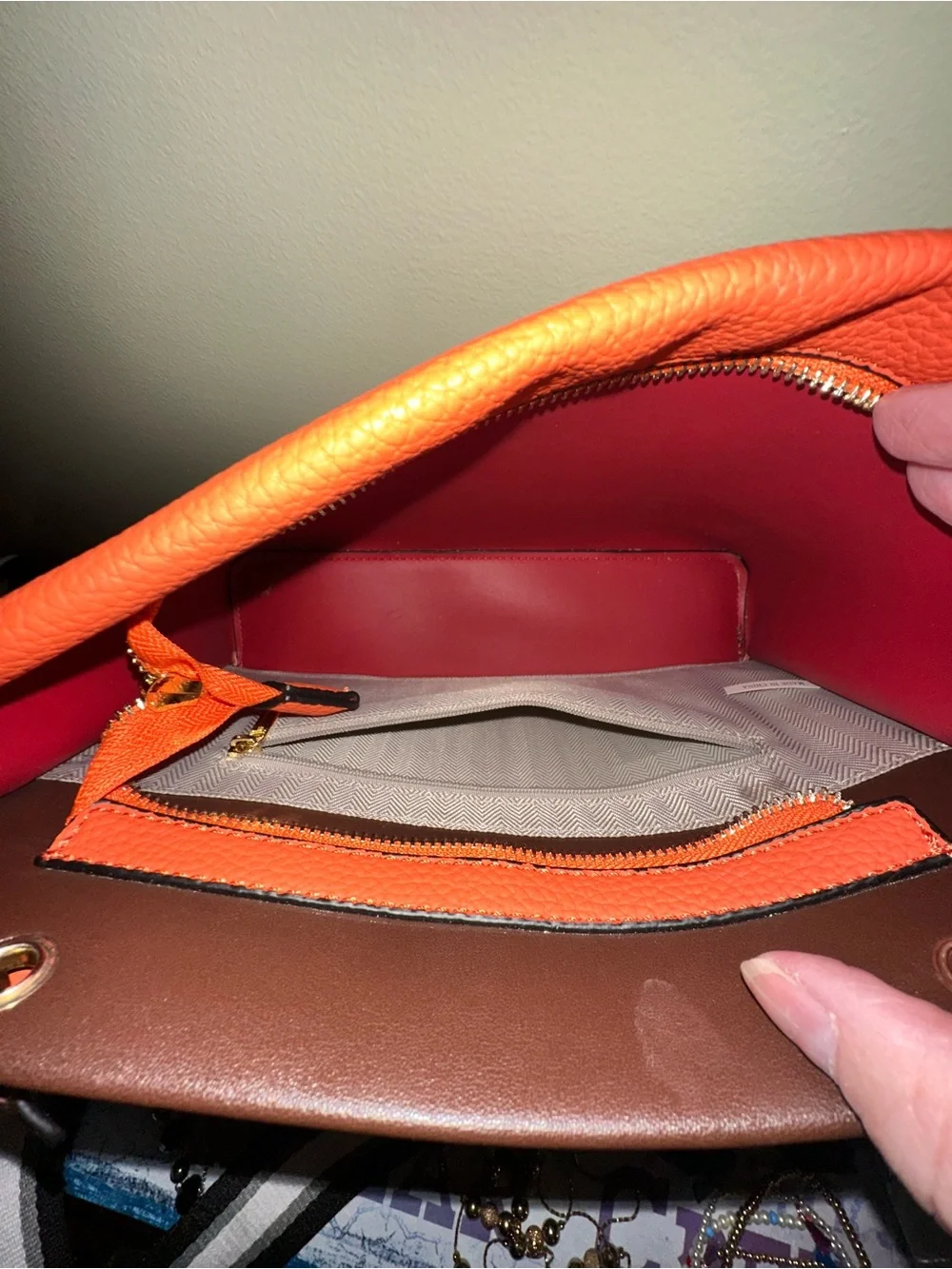 Orange hand Bag with Dark Brown Trim two crossbody straps..filled